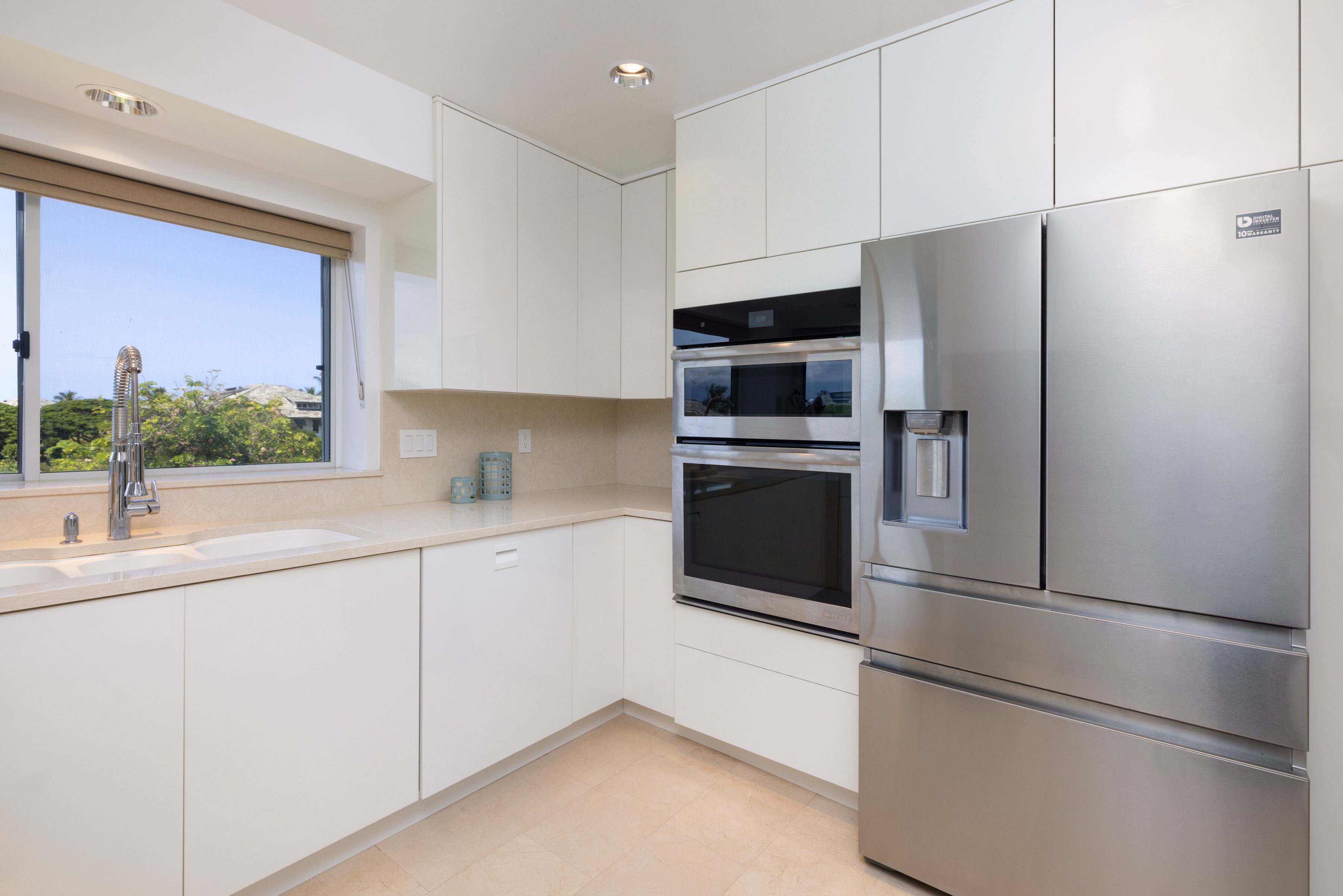 69-1010 Keana Place, Unit C202 Waikoloa, HI 96738 - Photo 14 of 30 a kitchen with stainless steel appliances a refrigerator sink and microwave