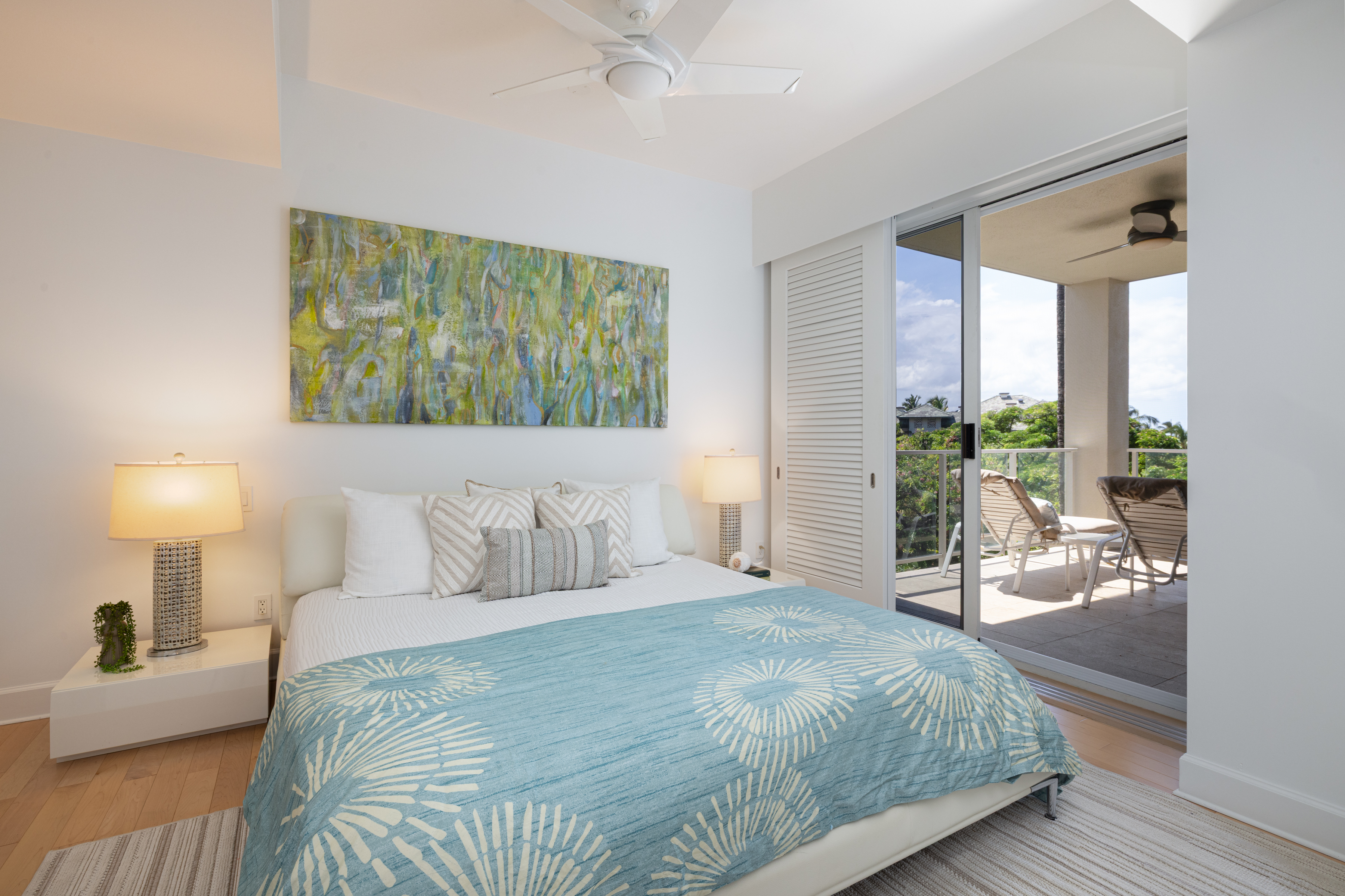 69-1010 Keana Place, Unit C202 Waikoloa, HI 96738 - Photo 16 of 30 a bedroom with a bed and a lamp on table