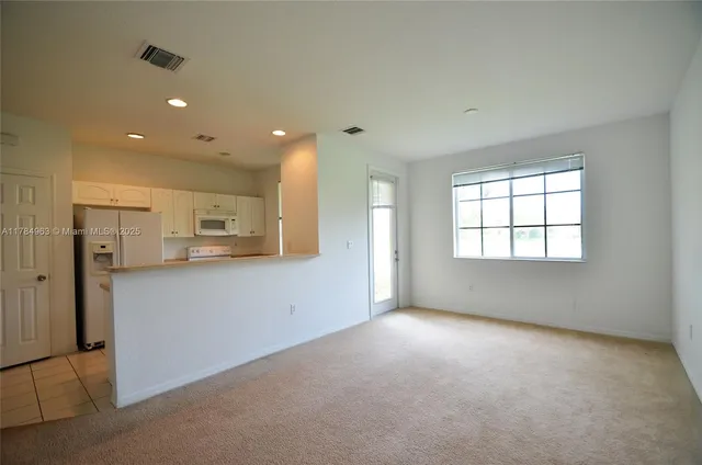 a kitchen with refrigerator and window