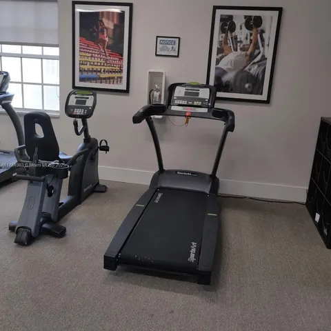 a room with gym equipment and a window