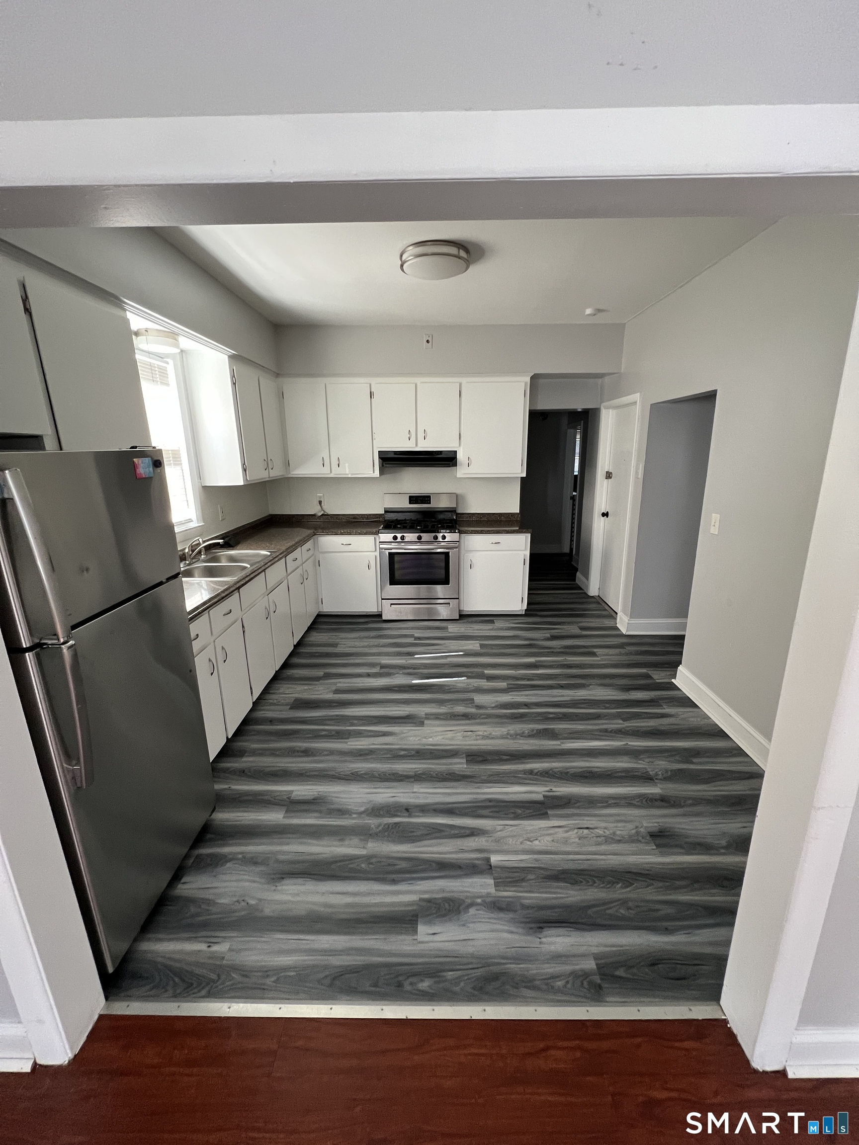 87 Amity Street Hartford, CT 06106 - Photo 12 of 38 a view of kitchen with sink microwave and refrigerator