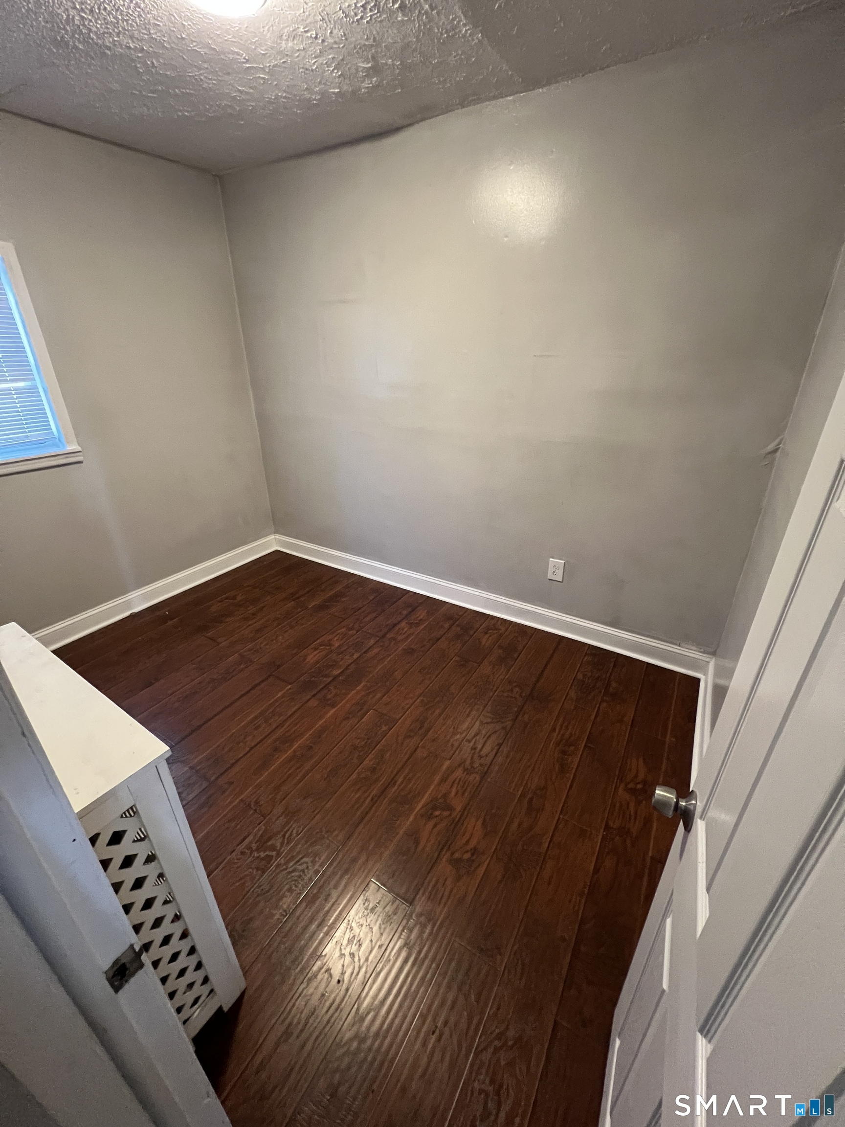 87 Amity Street Hartford, CT 06106 - Photo 13 of 38 a view of an empty room with wooden floor and staircase