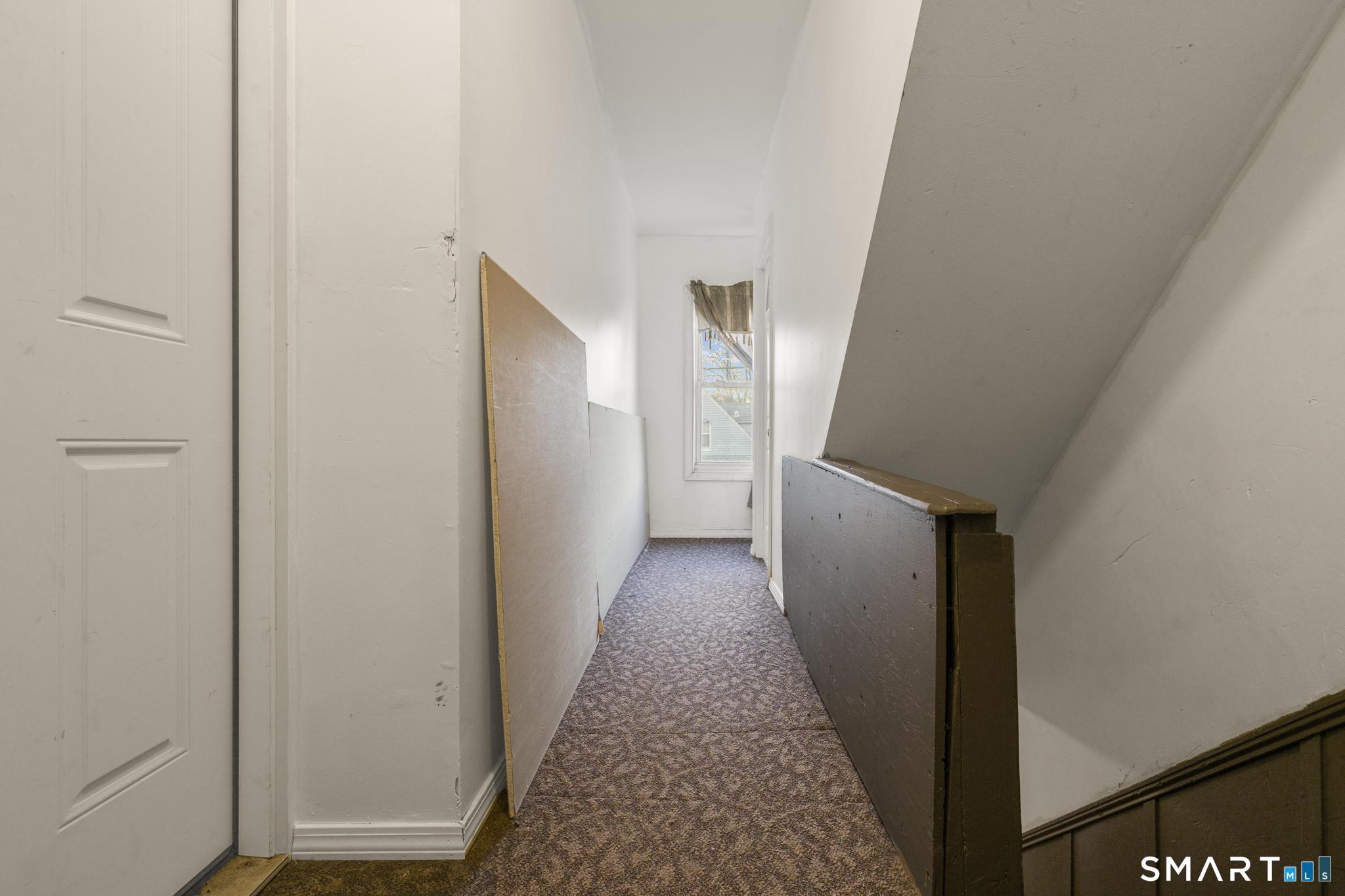 87 Amity Street Hartford, CT 06106 - Photo 21 of 38 a view of a hallway with wooden floor and staircase