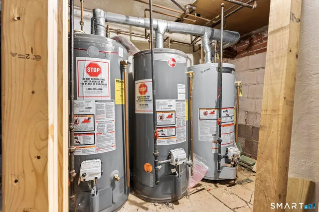 a utility room with fridge and closet