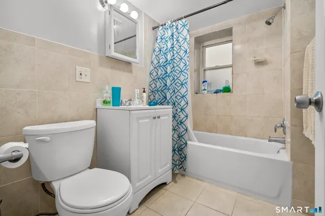 a bathroom with a toilet and shower