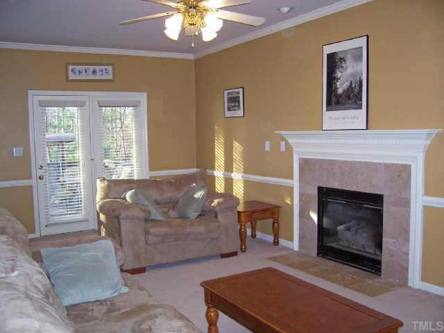 2036 Stoneglen Lane Raleigh, NC 27603 - Photo 5 of 12 Living room features chair rail and a fireplace with an attractive mantel and tile surround. Gas logs for those chilly evenings! Other