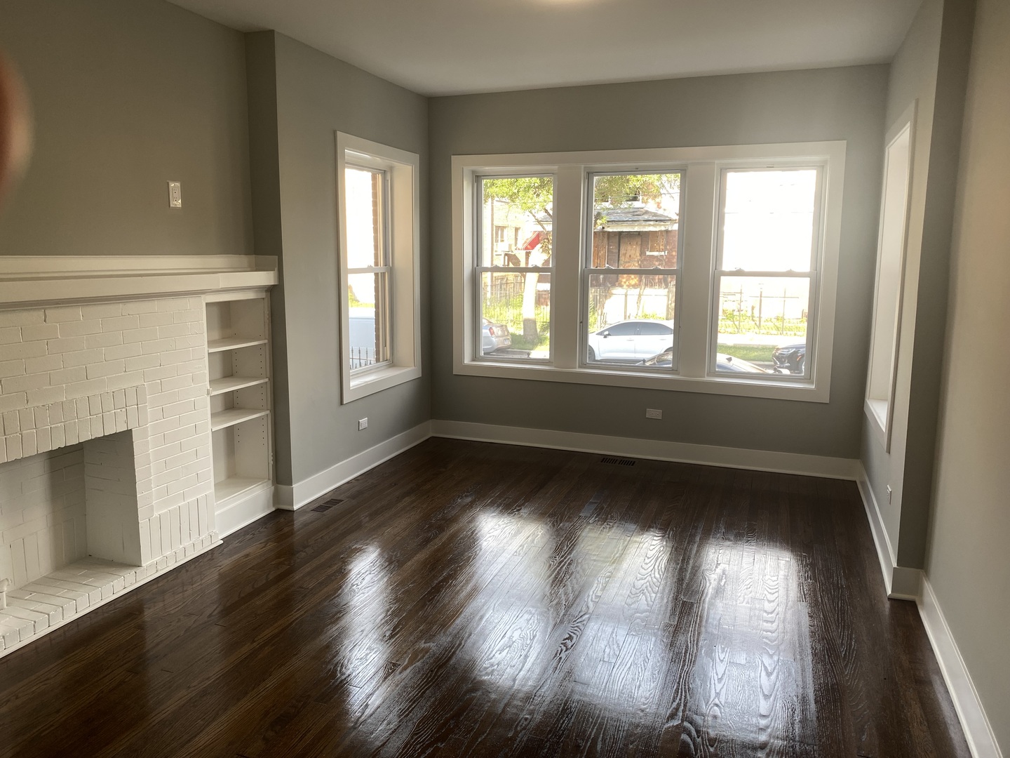 7835 South Carpenter Street Chicago, IL 60620 - Photo 13 of 17 an empty room with wooden floor and windows