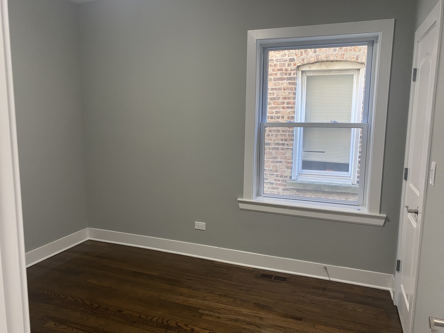 7835 South Carpenter Street Chicago, IL 60620 - Photo 16 of 17 a view of an empty room with wooden floor and a window