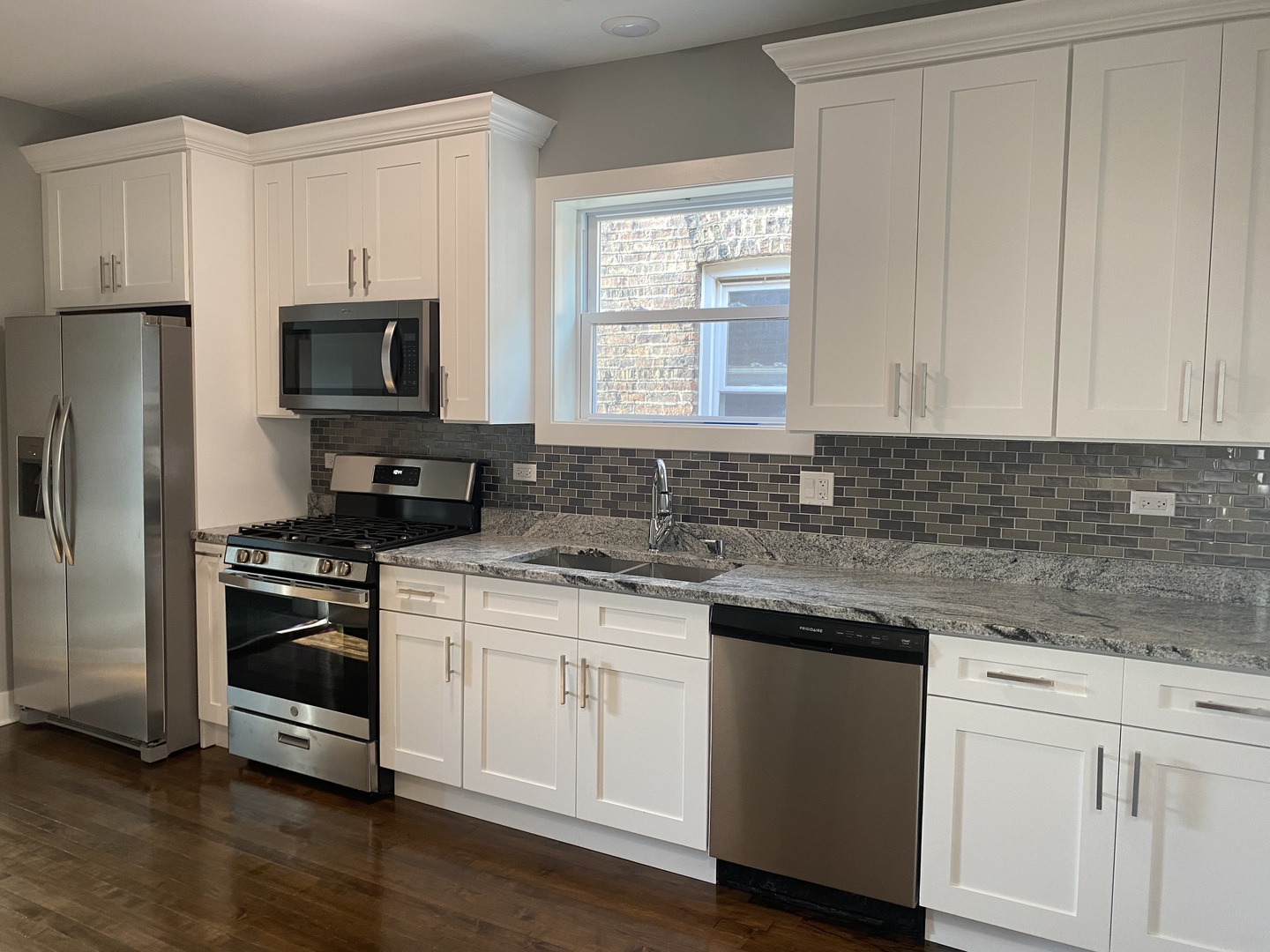 7835 South Carpenter Street Chicago, IL 60620 - Photo 2 of 17 a kitchen with appliances a sink and a window