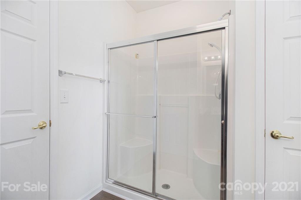287 Garnet Court Fort Mill, SC 29708 - Photo 17 of 30 a bathroom with a glass shower door