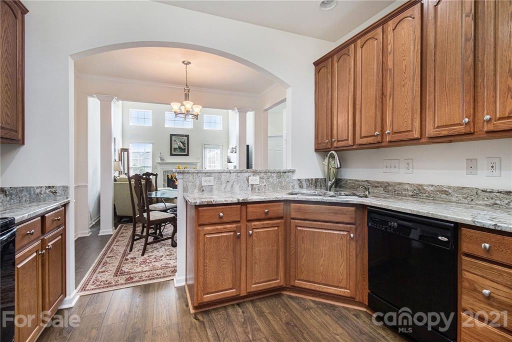 287 Garnet Court Fort Mill, SC 29708 - Photo 4 of 30 a kitchen with stainless steel appliances granite countertop a stove a sink dishwasher and a refrigerator with wooden floor