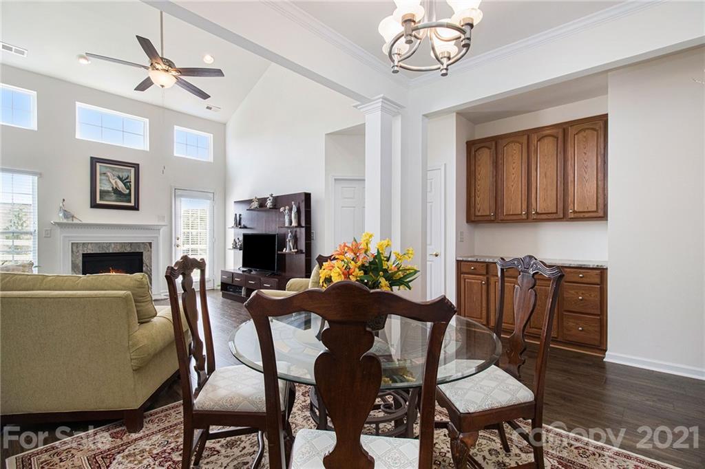 287 Garnet Court Fort Mill, SC 29708 - Photo 6 of 30 a view of a dining room with furniture wooden floor and a fireplace