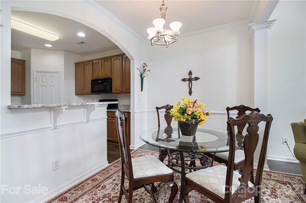 287 Garnet Court Fort Mill, SC 29708 - Photo 7 of 30 a view of a dining room with furniture and chandelier