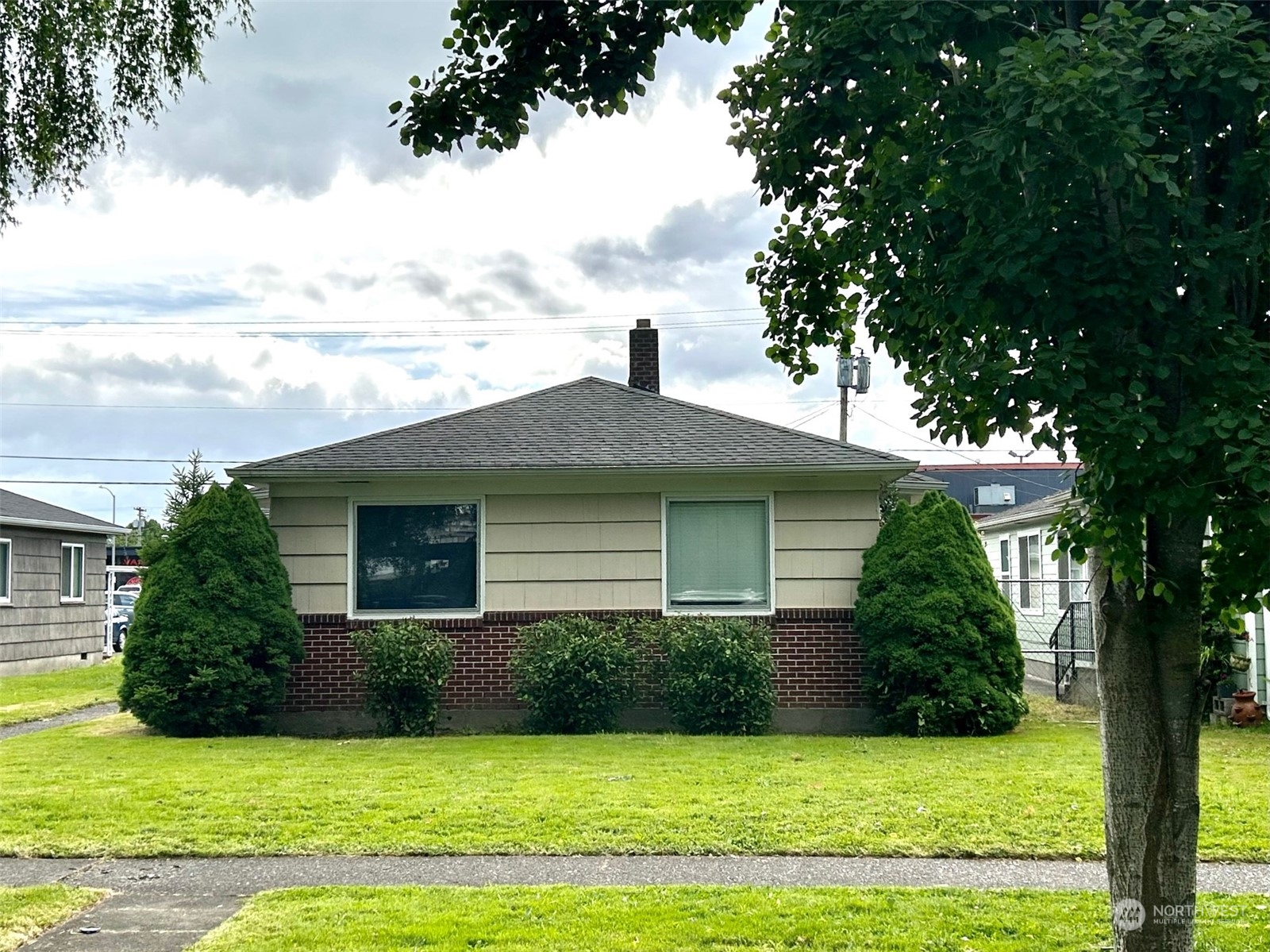 a front view of a house with yard and green space
