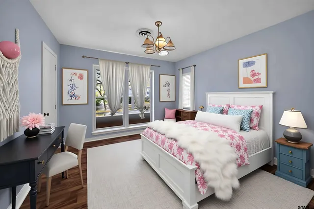 a kitchen with granite countertop a stove a sink and white cabinets with wooden floor