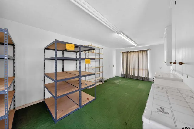 a view of a bedroom with furniture and windows