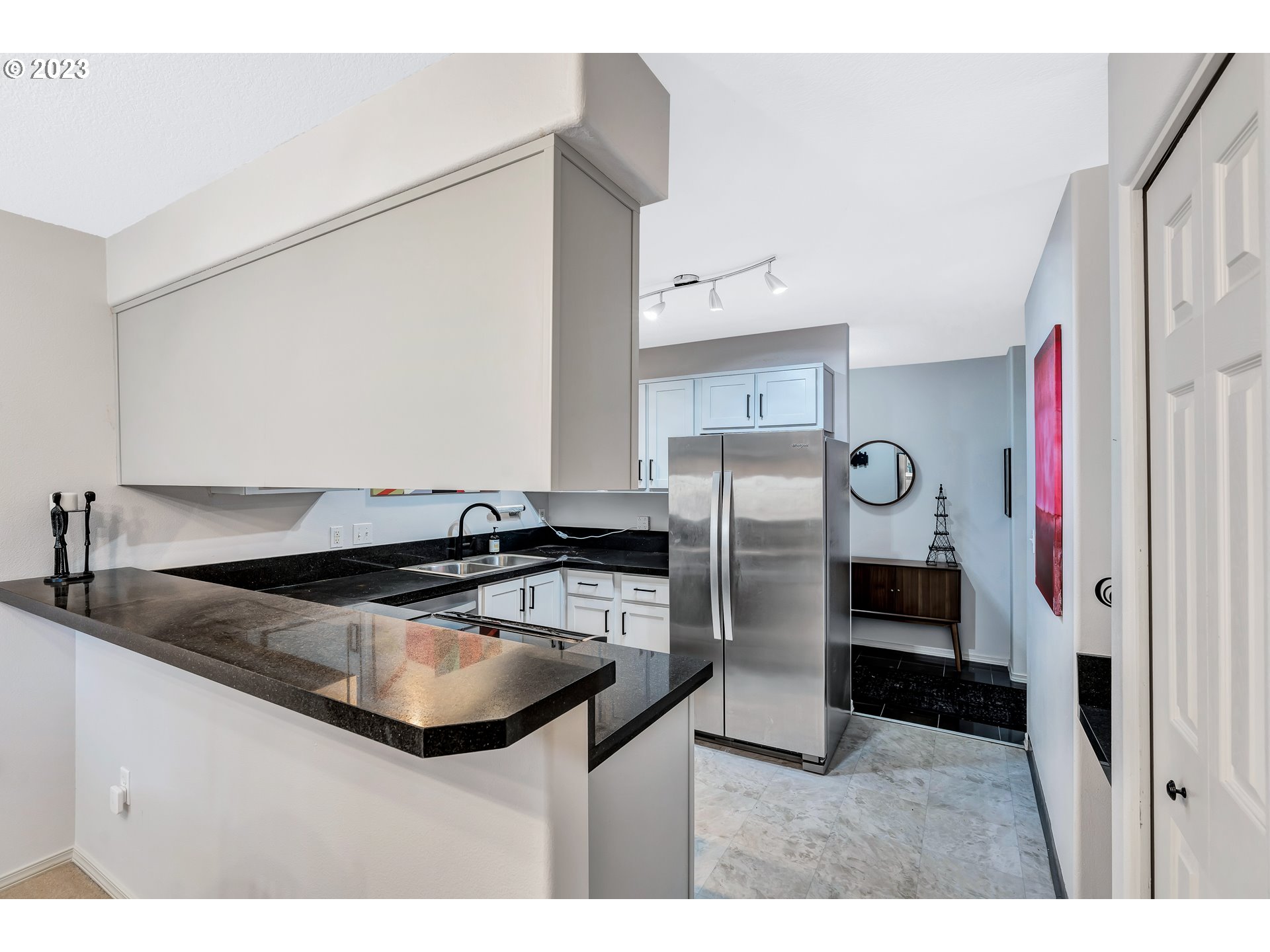 4694 West Powell Boulevard, Unit 139 Gresham, OR 97030 - Photo 12 of 29 a kitchen with stainless steel appliances granite countertop a sink stove and refrigerator