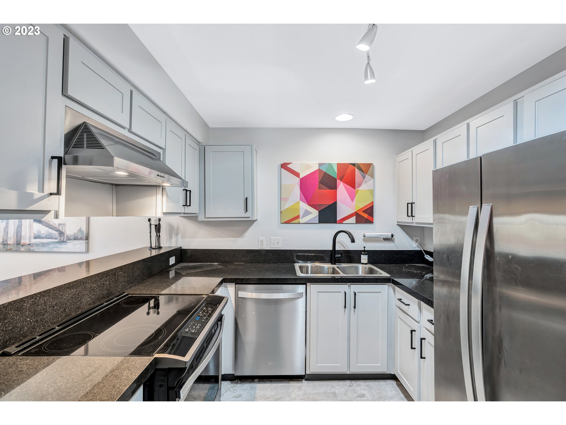 4694 West Powell Boulevard, Unit 139 Gresham, OR 97030 - Photo 13 of 29 a kitchen with stainless steel appliances a sink a stove a refrigerator and cabinets