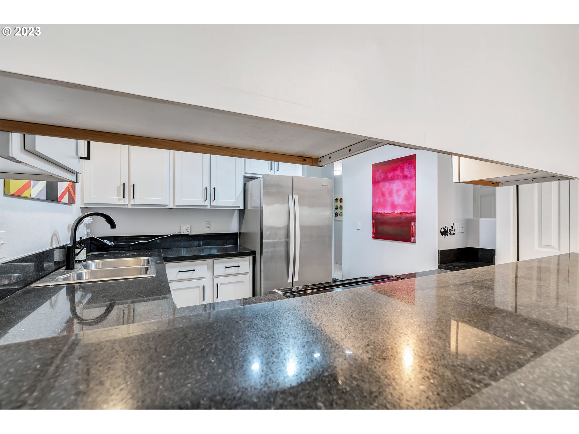 4694 West Powell Boulevard, Unit 139 Gresham, OR 97030 - Photo 14 of 29 a kitchen with stainless steel appliances granite countertop a sink refrigerator and stove