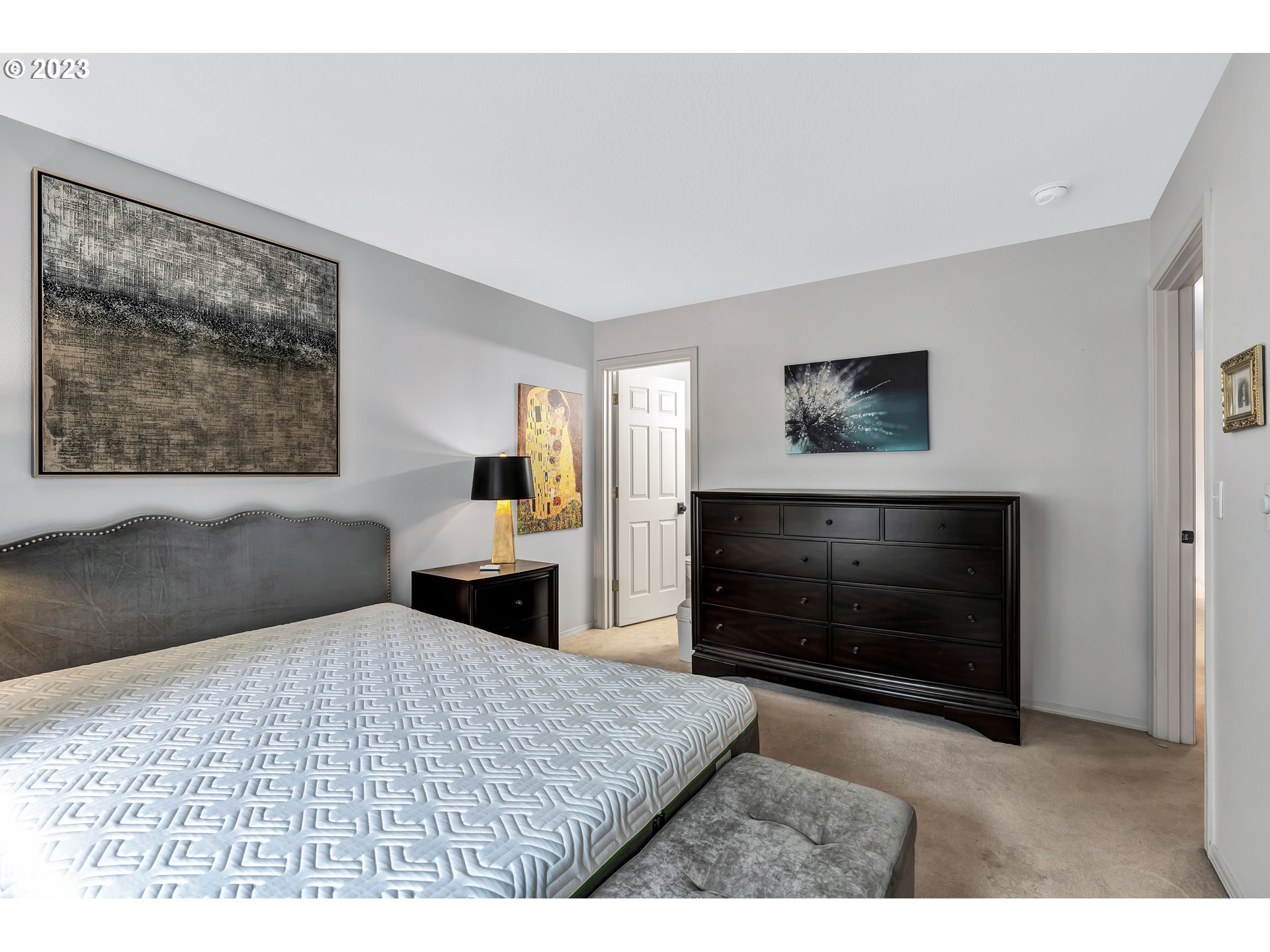 4694 West Powell Boulevard, Unit 139 Gresham, OR 97030 - Photo 16 of 29 a bedroom with a bed and a flat screen tv