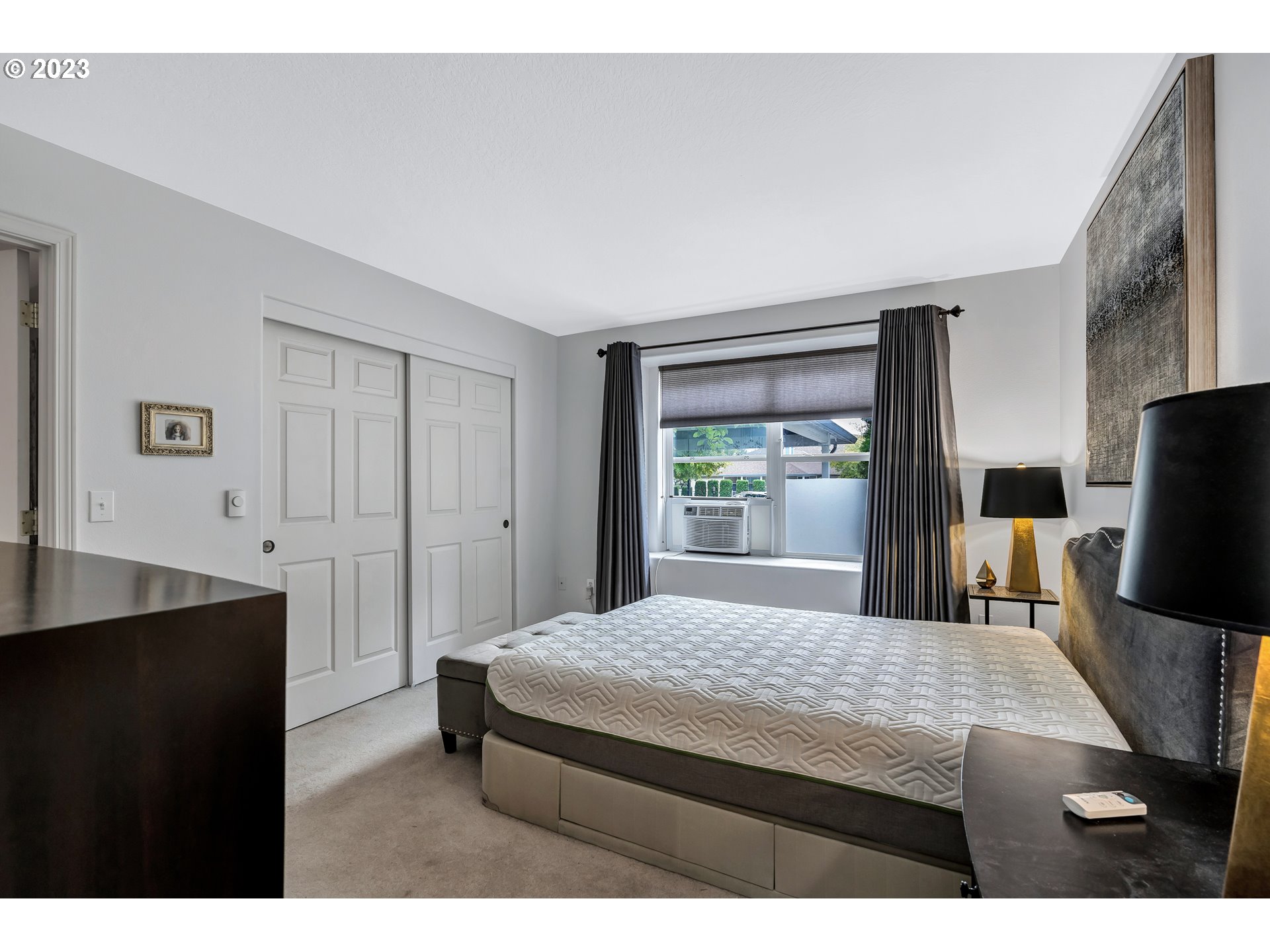 4694 West Powell Boulevard, Unit 139 Gresham, OR 97030 - Photo 17 of 29 a living room with a bed furniture and a large window