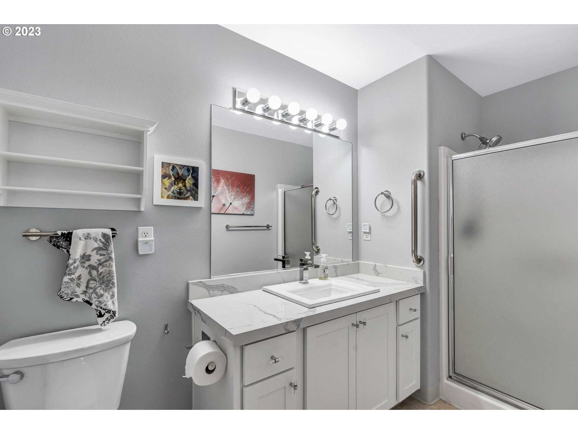 4694 West Powell Boulevard, Unit 139 Gresham, OR 97030 - Photo 18 of 29 a bathroom with a sink a toilet a mirror and shower