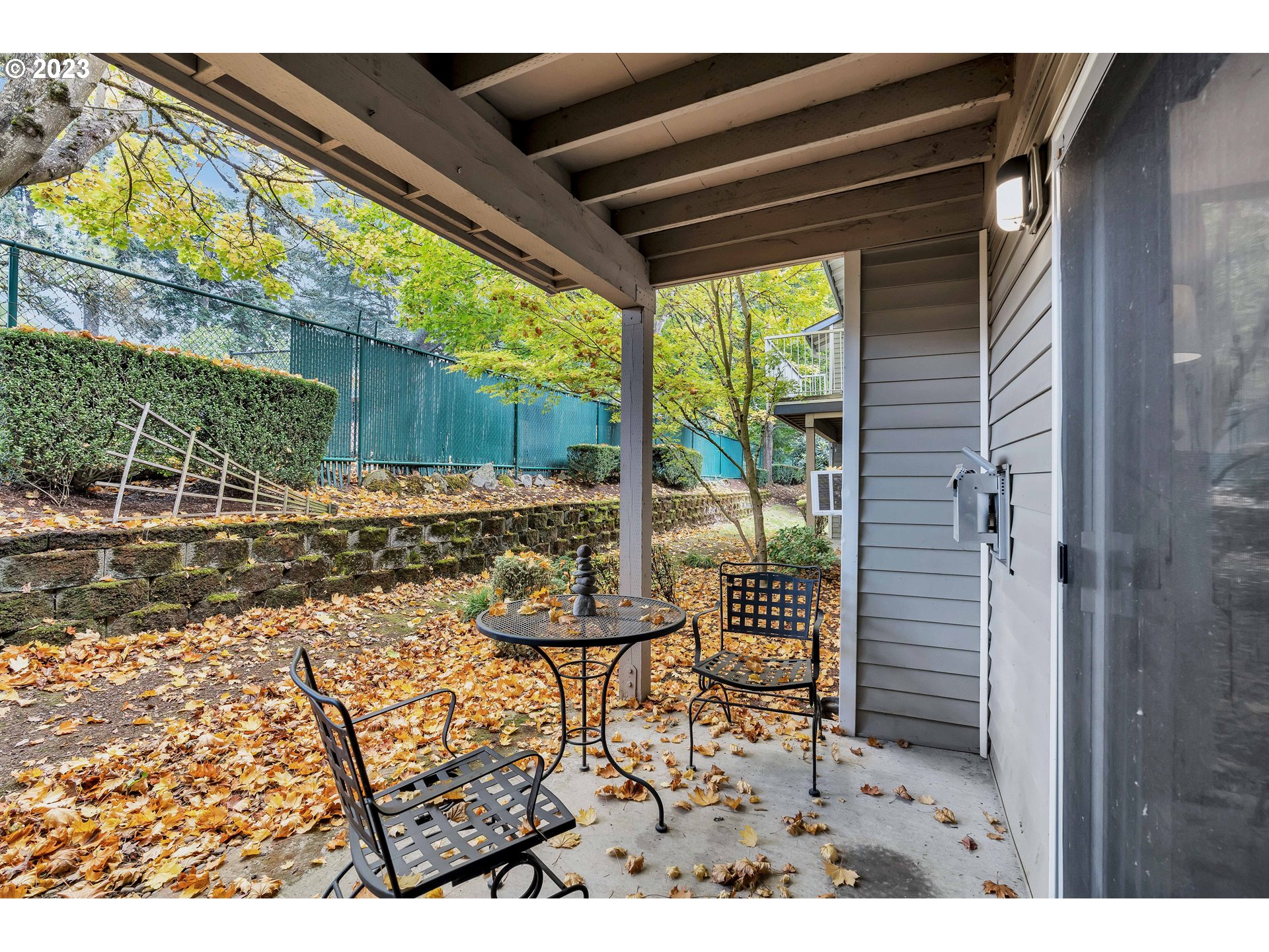 4694 West Powell Boulevard, Unit 139 Gresham, OR 97030 - Photo 23 of 29 a view of a porch with furniture and floor to ceiling window