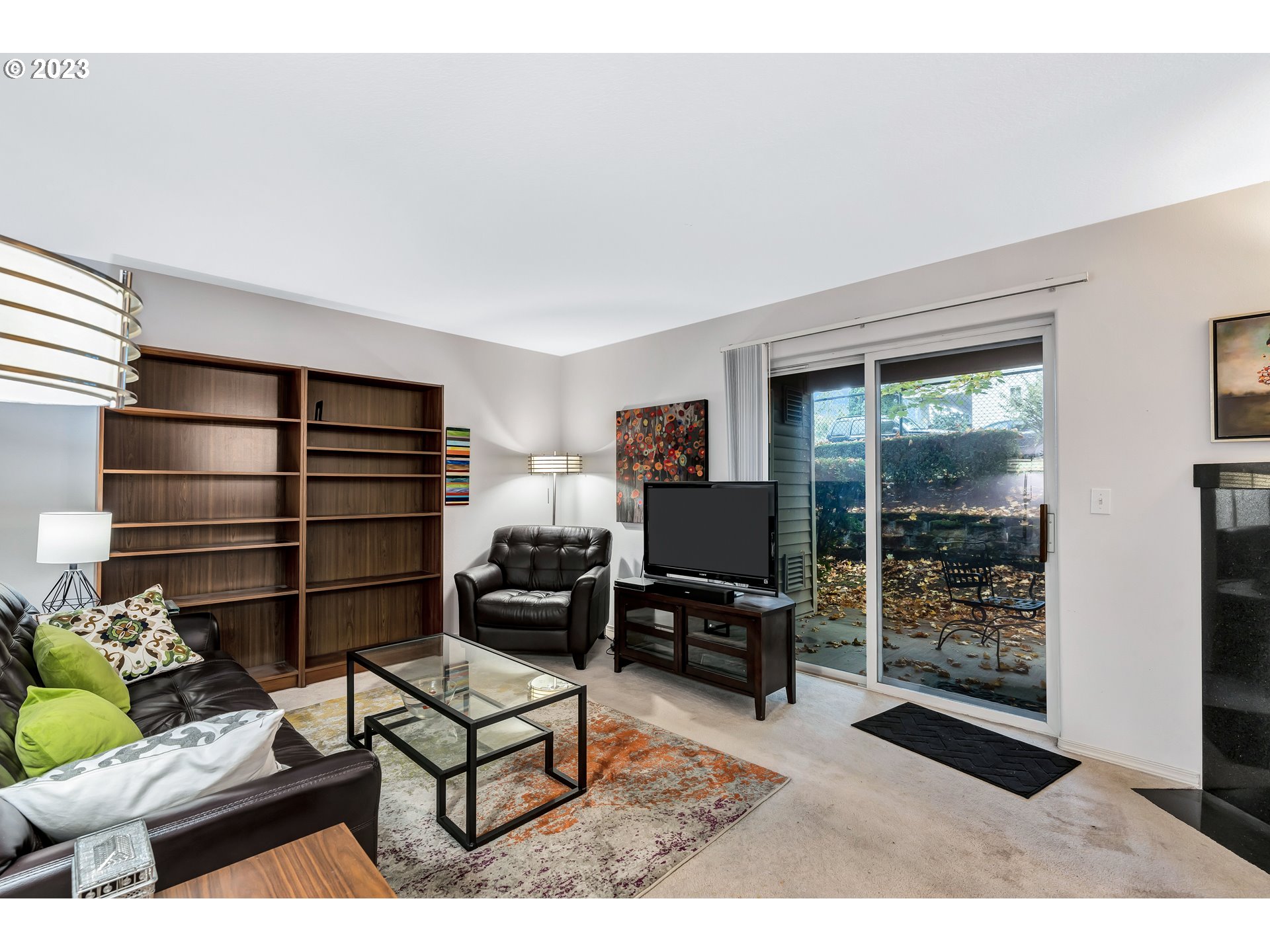 4694 West Powell Boulevard, Unit 139 Gresham, OR 97030 - Photo 7 of 29 a living room with furniture a rug and a flat screen tv