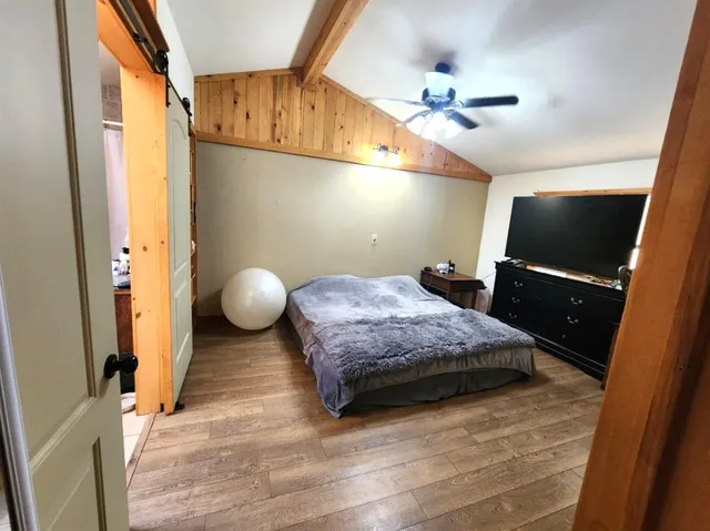 a bedroom with a bed and a mirror