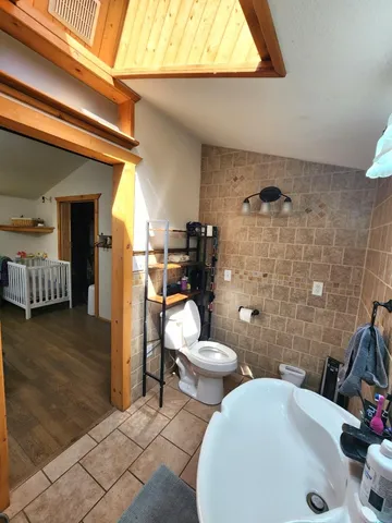 a living room with lots of furniture and a book shelf