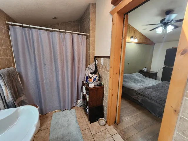 a living room with furniture and a book shelf
