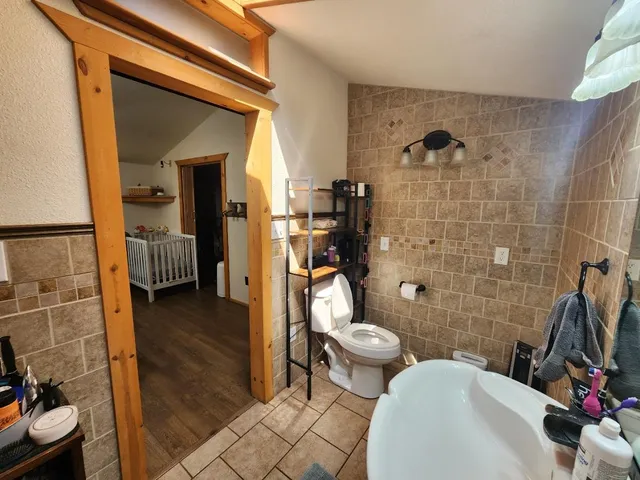 a view of a patio with table and chairs with wooden floor and fence
