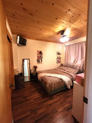 a view of a balcony with chairs and wooden floor