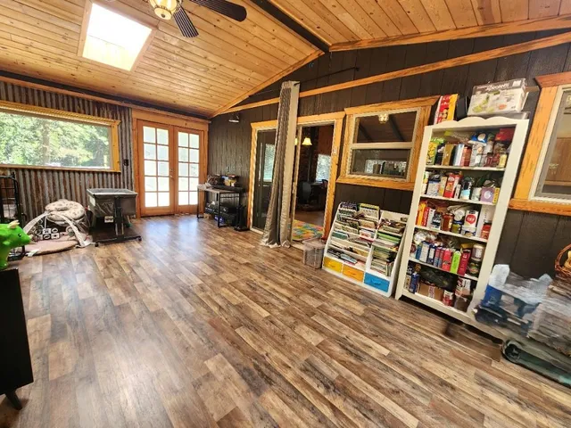 a room with water heater and wooden cabinets