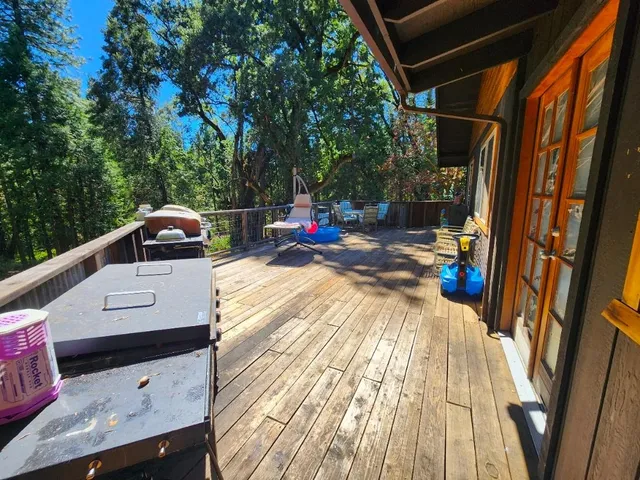 a view of a street with a bench and trees around