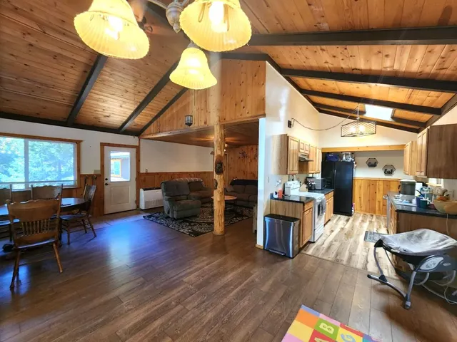 a bedroom with a bed and a flat tv screen on dresser