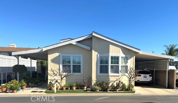 7271 Katella Avenue, Unit 99 Stanton, CA 90680 - Photo 1 of 15 a view of a house with a yard