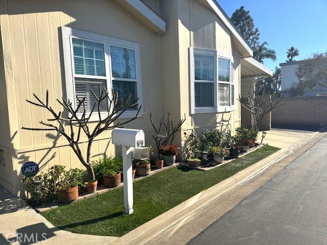 7271 Katella Avenue, Unit 99 Stanton, CA 90680 - Photo 3 of 15 a front view of a house with garden