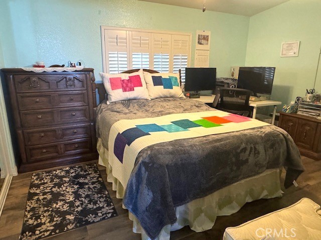 7271 Katella Avenue, Unit 99 Stanton, CA 90680 - Photo 8 of 15 a bed sitting in a bedroom next to a window