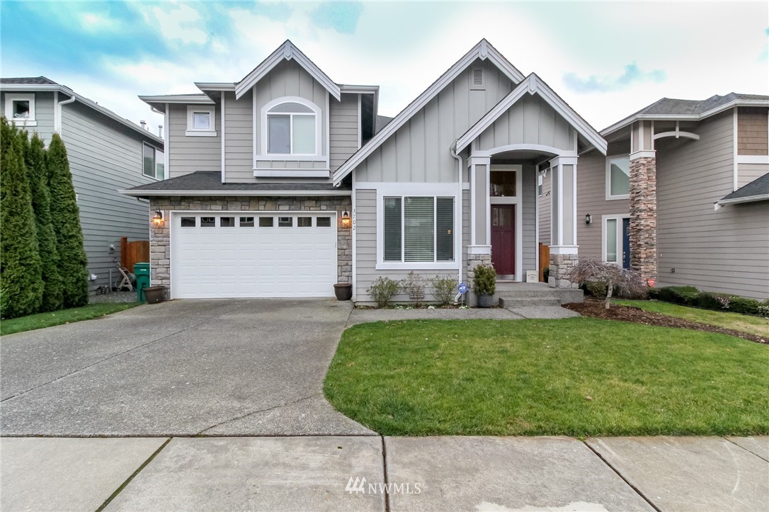 3702 222nd Place Southeast Bothell, WA 98021 - Photo 1 of 1 a front view of a house with a yard and garage