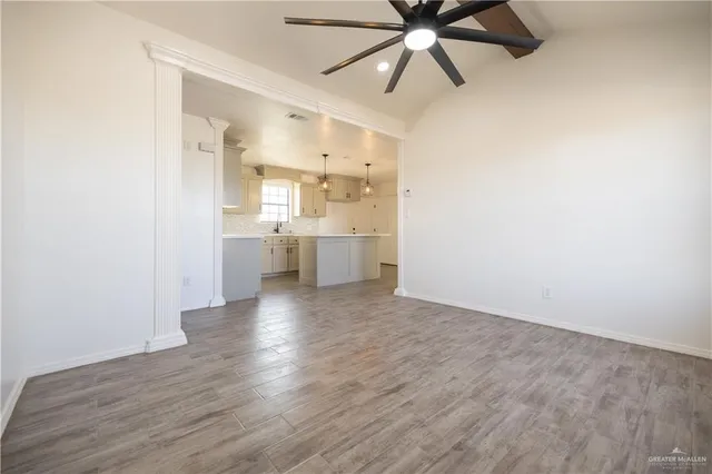 a kitchen with a sink window and cabinets