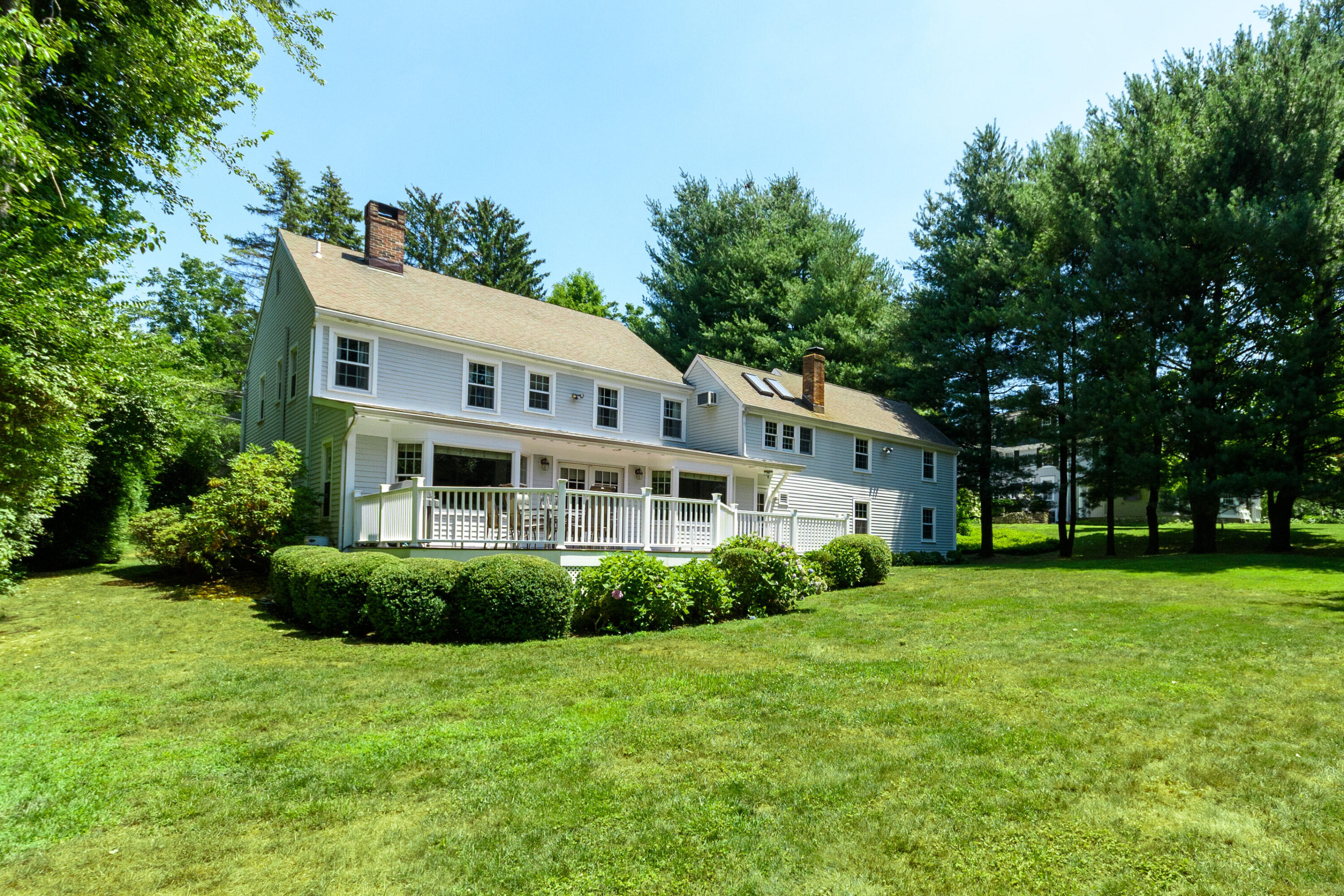 2 Red Barn Road Darien, CT 06820 - Photo 27 of 36 a front view of a house with a garden