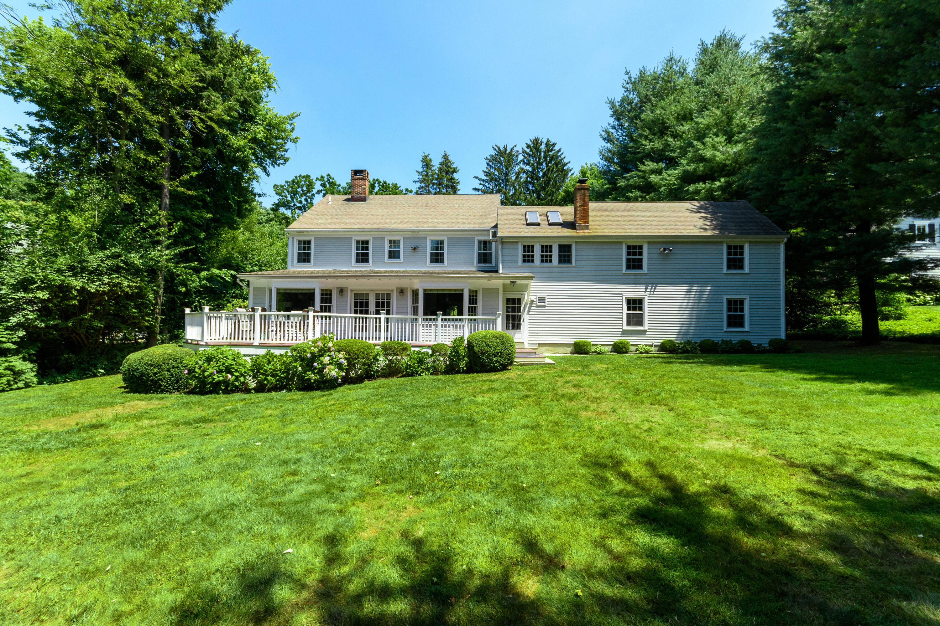 2 Red Barn Road Darien, CT 06820 - Photo 28 of 36 a front view of a house with a garden