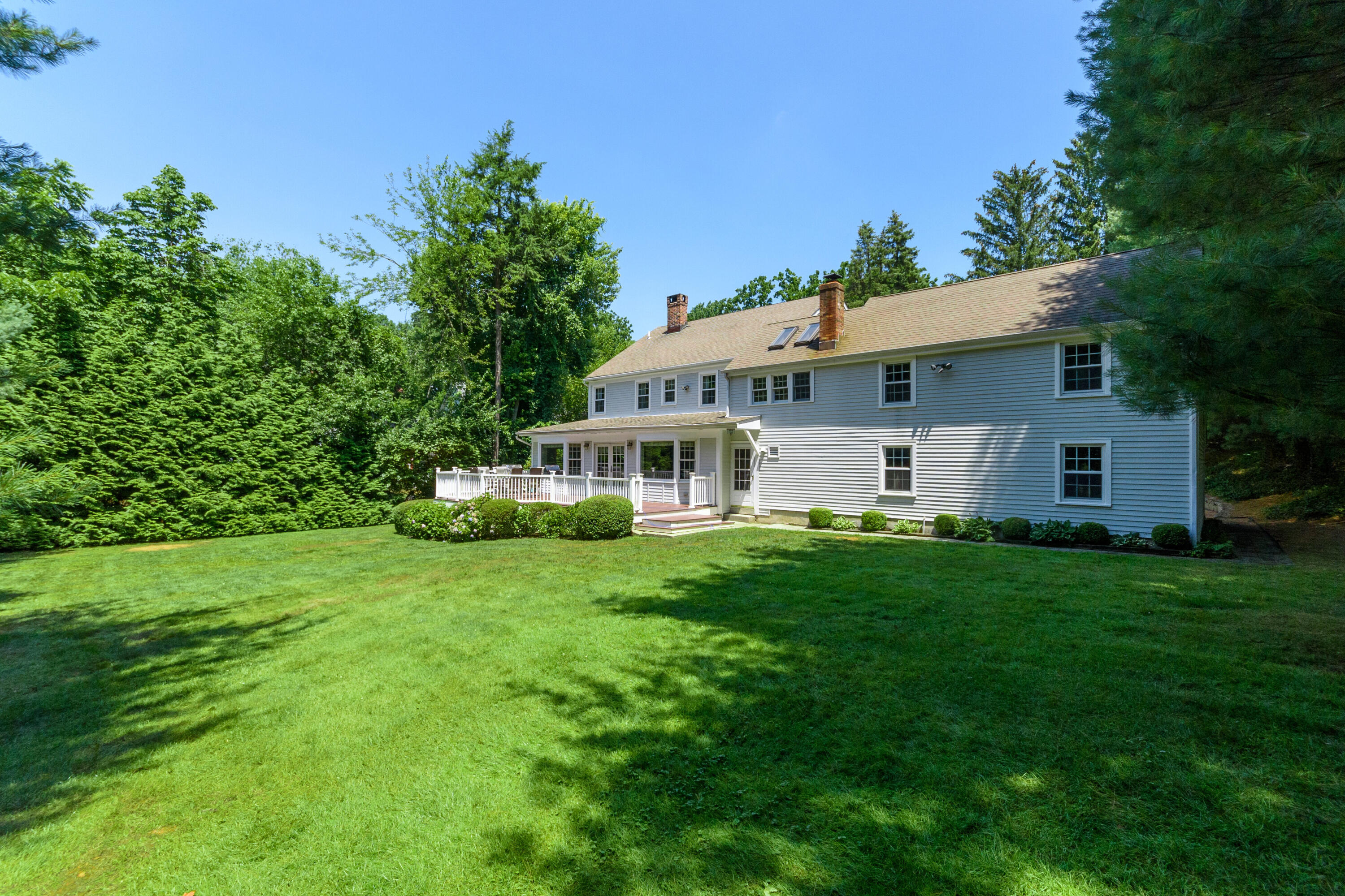 2 Red Barn Road Darien, CT 06820 - Photo 29 of 36 a front view of a house with a garden