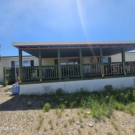 a view of a house with backyard and porch