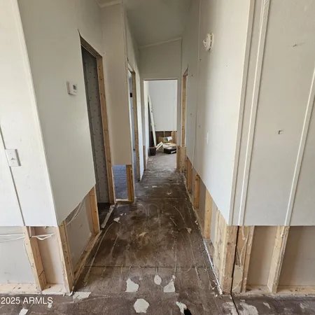 a view of a hallway with furniture