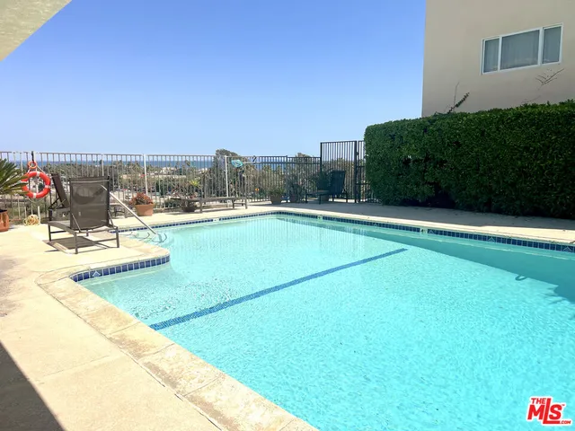 a view of a terrace with a table and chairs