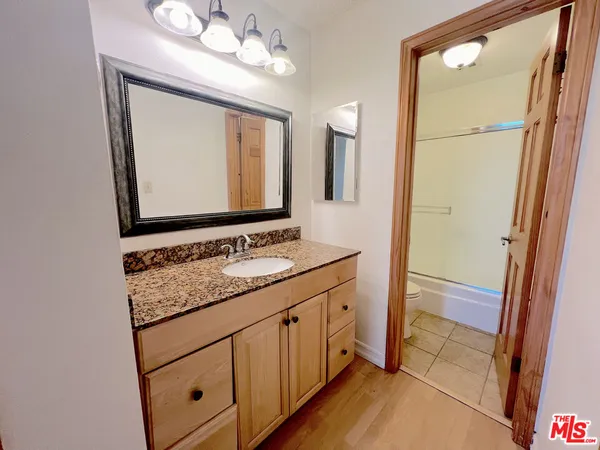 a bathroom with a sink a mirror and a vanity