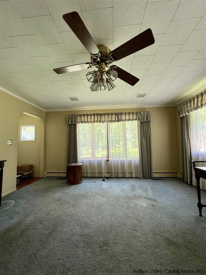 72 Union Center Road Ulster Park, NY 12487 - Photo 5 of 11 a view of a livingroom with a ceiling fan and window