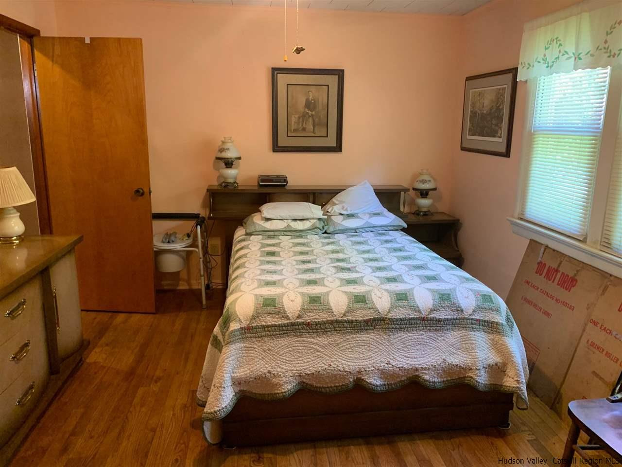 72 Union Center Road Ulster Park, NY 12487 - Photo 7 of 11 a bedroom with a bed and wooden floor